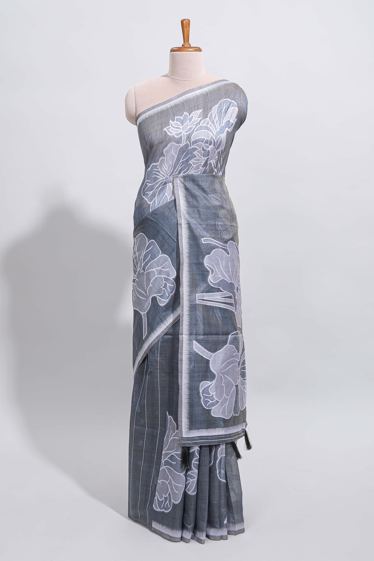 Charcoal grey with white floral print tussar saree with self sleek serrated border and matching blouse