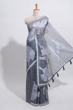 Charcoal grey with white floral print tussar saree with self sleek serrated border and matching blouse