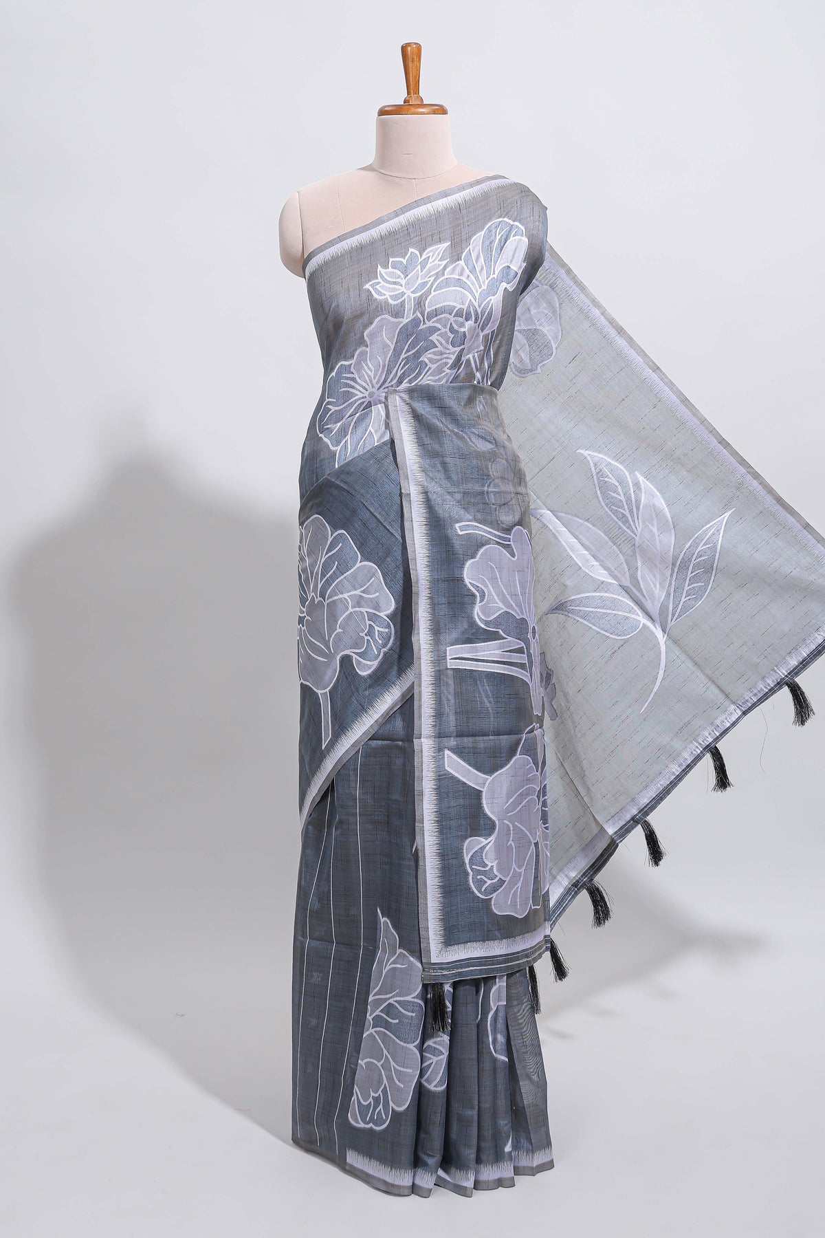 Charcoal grey with white floral print tussar saree with self sleek serrated border and matching blouse