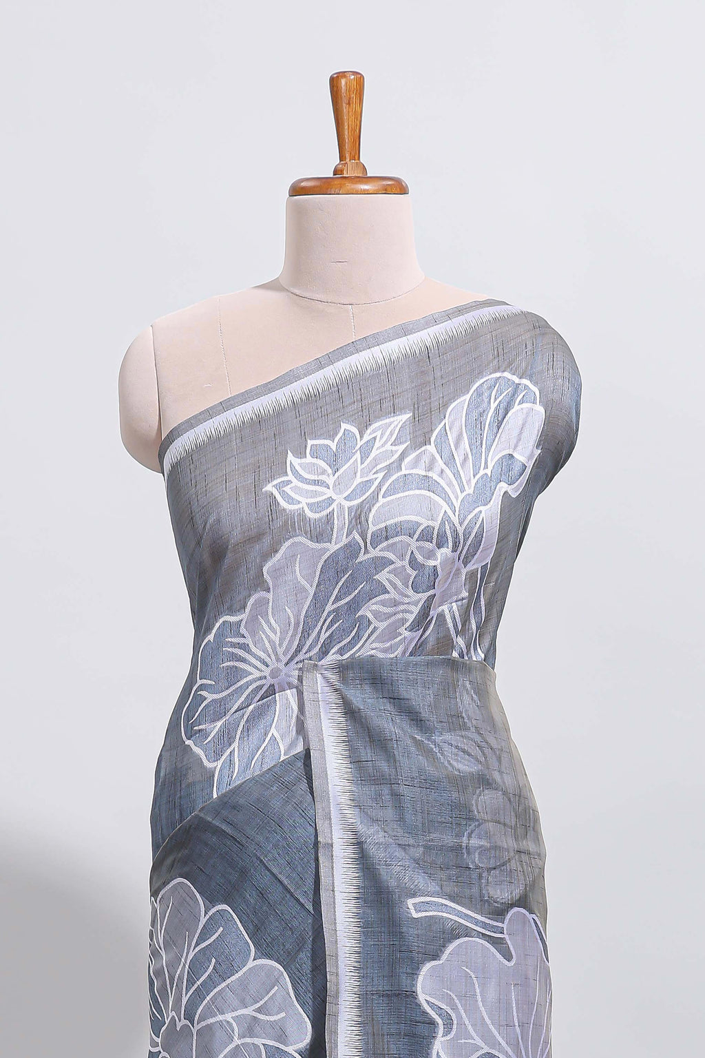 Charcoal grey with white floral print tussar saree with self sleek serrated border and matching blouse