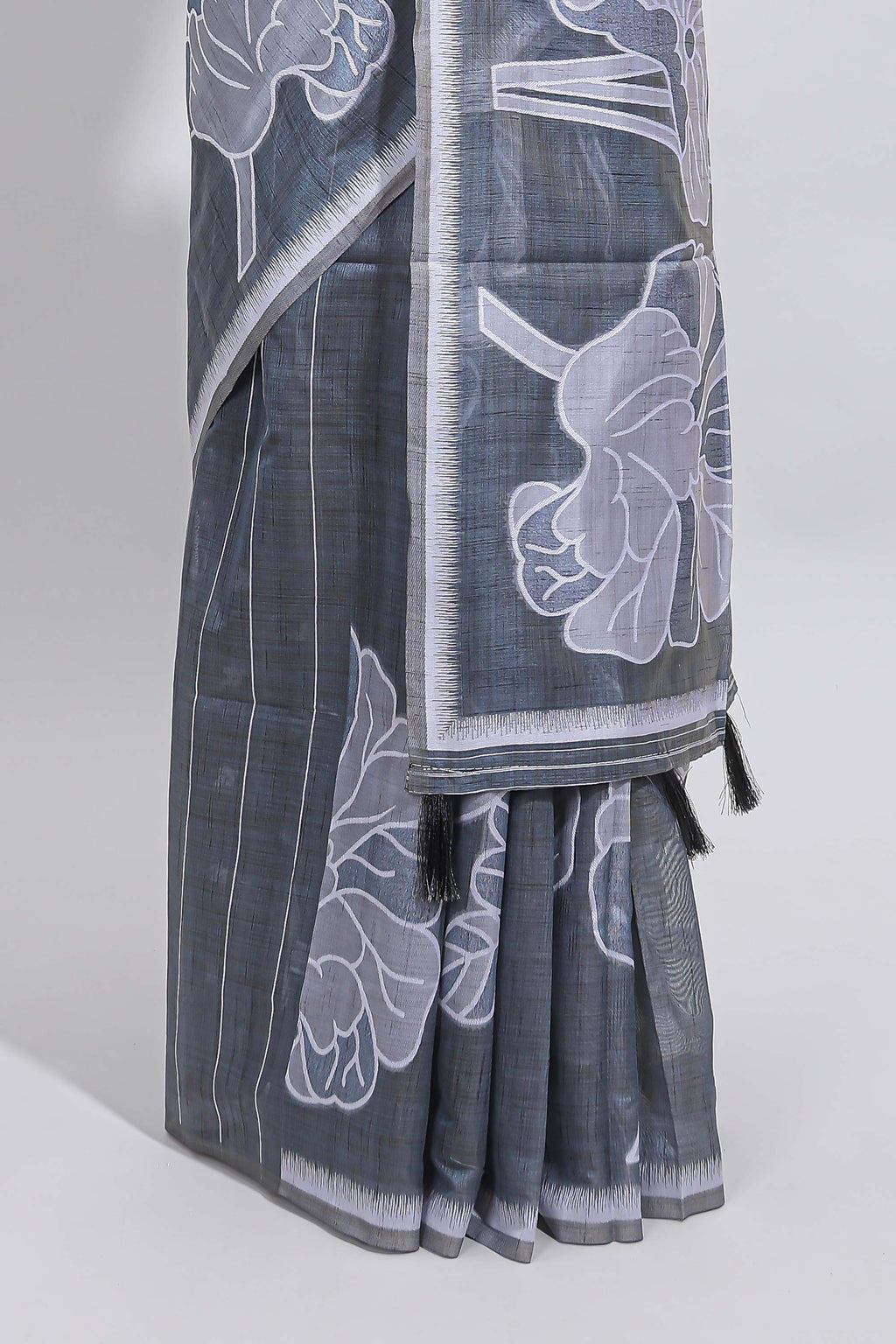 Charcoal grey with white floral print tussar saree with self sleek serrated border and matching blouse