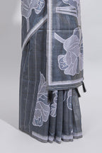 Charcoal grey with white floral print tussar saree with self sleek serrated border and matching blouse