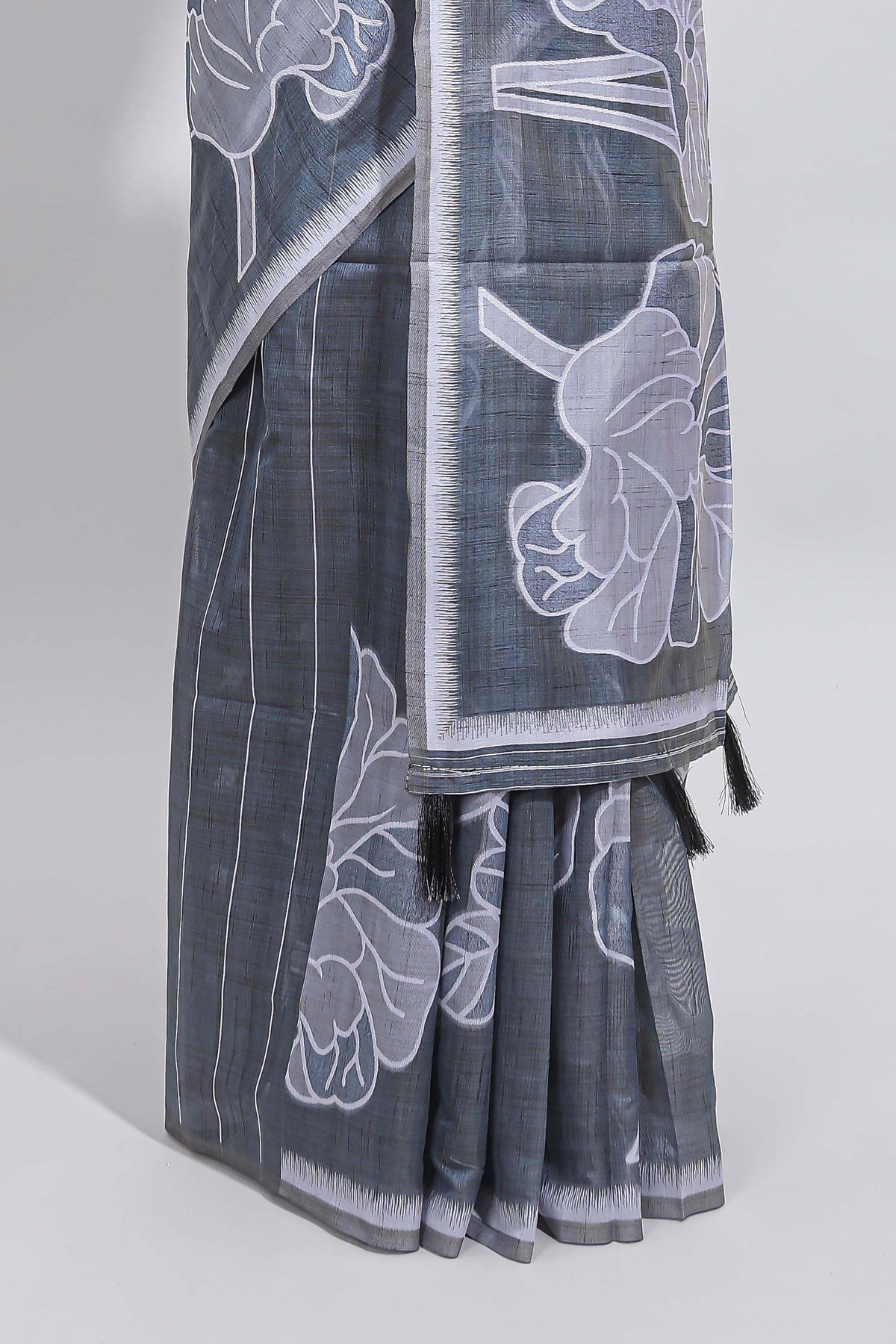 Charcoal grey with white floral print tussar saree with self sleek serrated border and matching blouse