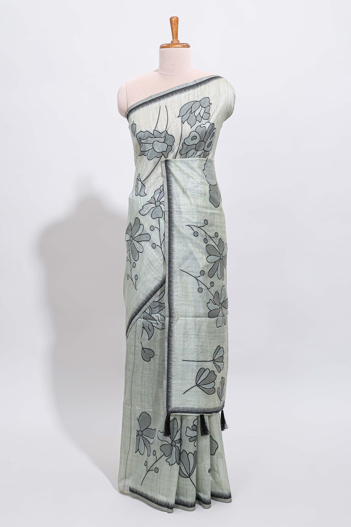 Sage green with charcoal grey floral print tussar saree with self sleek serrated border and matching blouse