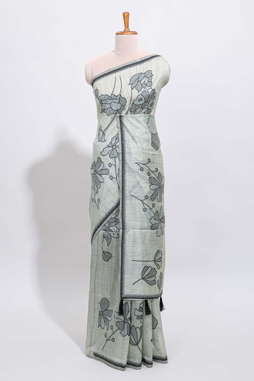 Sage green with charcoal grey floral print tussar saree with self sleek serrated border and matching blouse