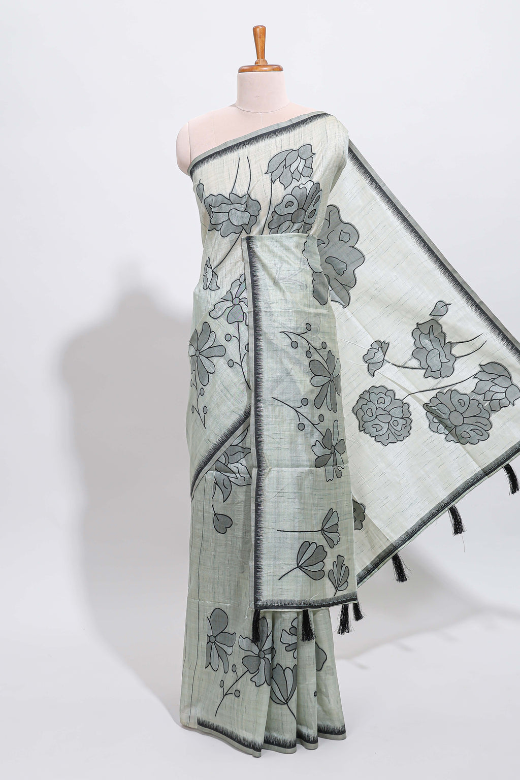 Sage green with charcoal grey floral print tussar saree with self sleek serrated border and matching blouse
