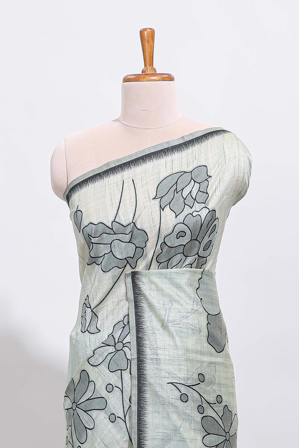 Sage green with charcoal grey floral print tussar saree with self sleek serrated border and matching blouse