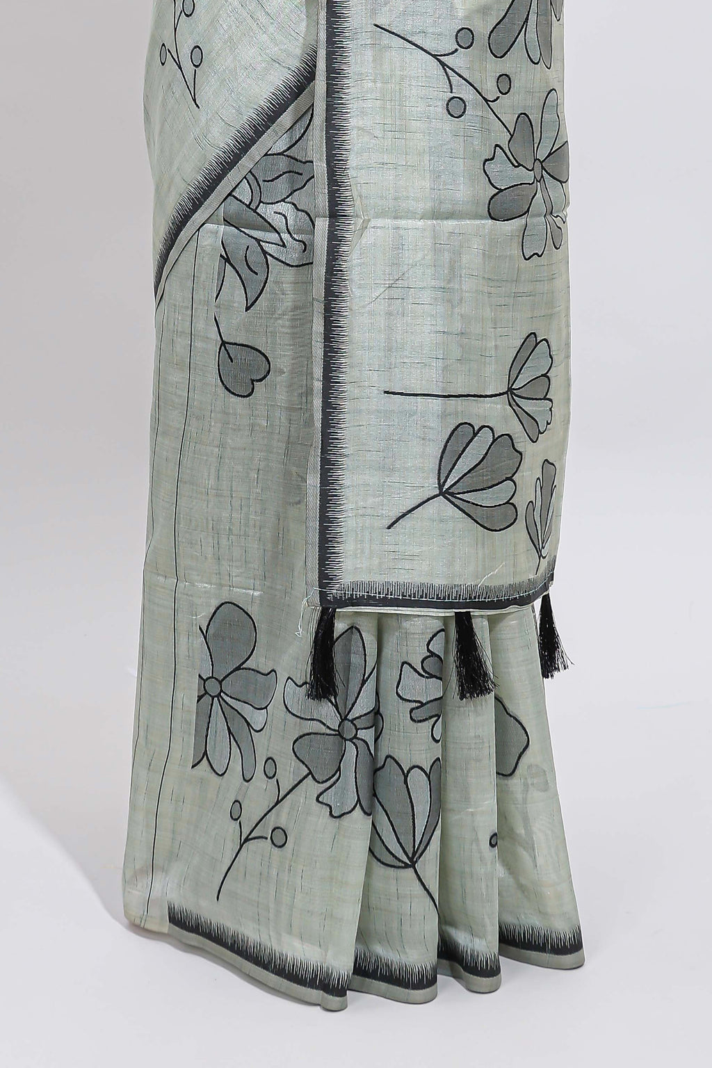 Sage green with charcoal grey floral print tussar saree with self sleek serrated border and matching blouse