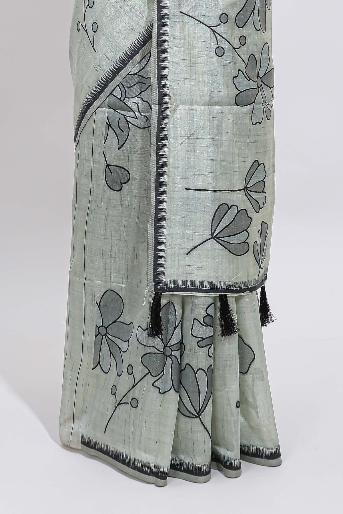 Sage green with charcoal grey floral print tussar saree with self sleek serrated border and matching blouse