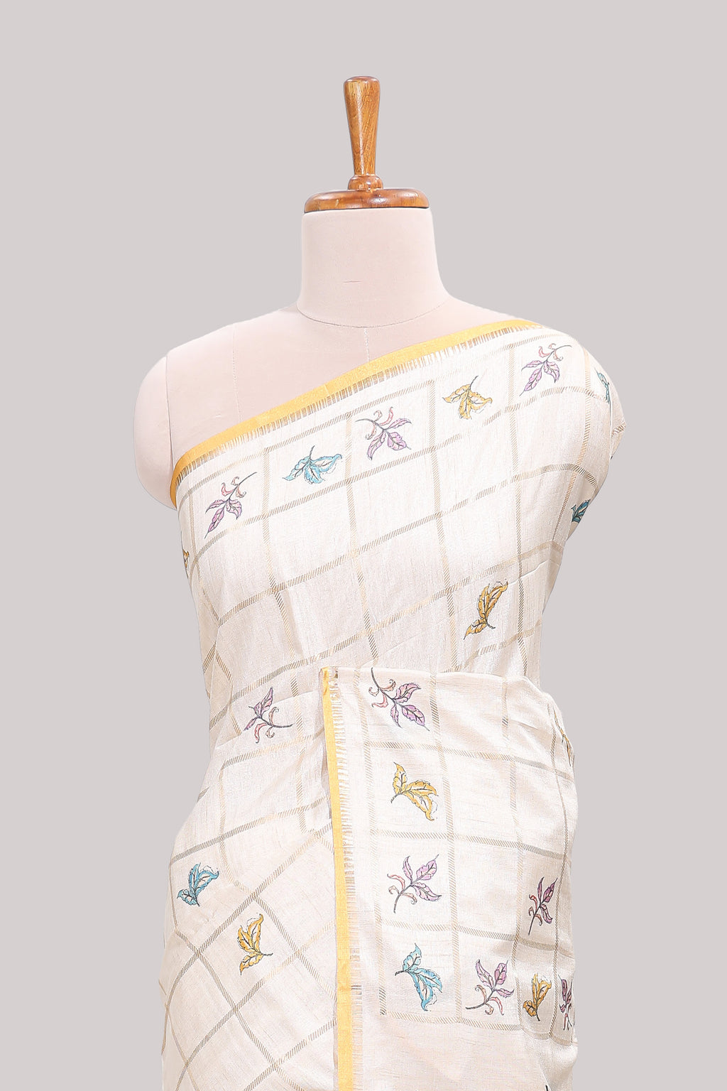 Off white checked tussar saree with contrast border and pallu that comes with matching floral blouse