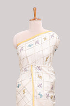 Off white checked tussar saree with contrast border and pallu that comes with matching floral blouse