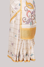 Off white checked tussar saree with contrast border and pallu that comes with matching floral blouse