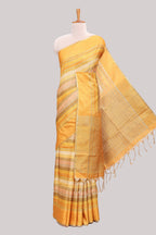 Yellow striped tussar saree with self border and pallu that comes with matching blouse