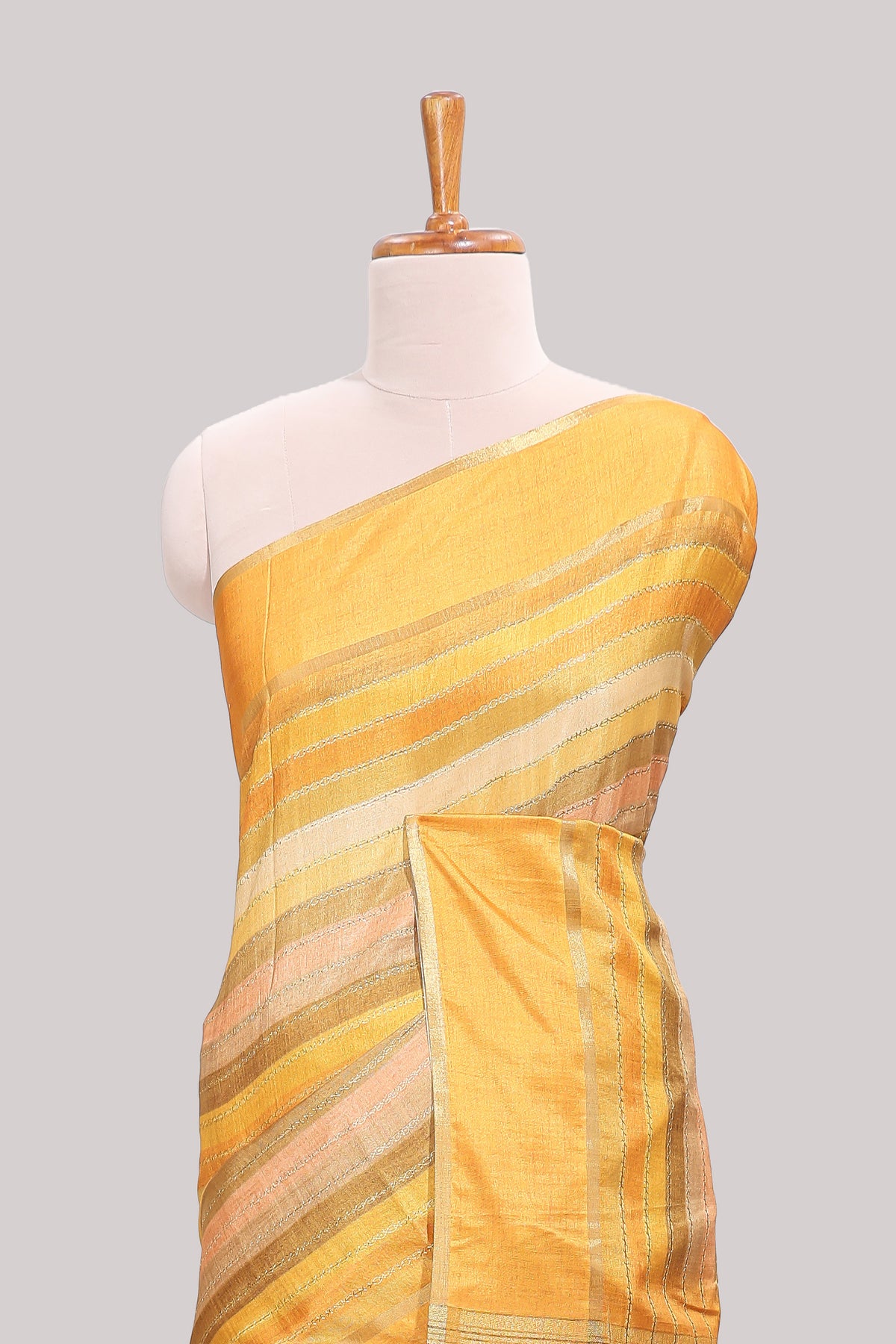 Yellow striped tussar saree with self border and pallu that comes with matching blouse