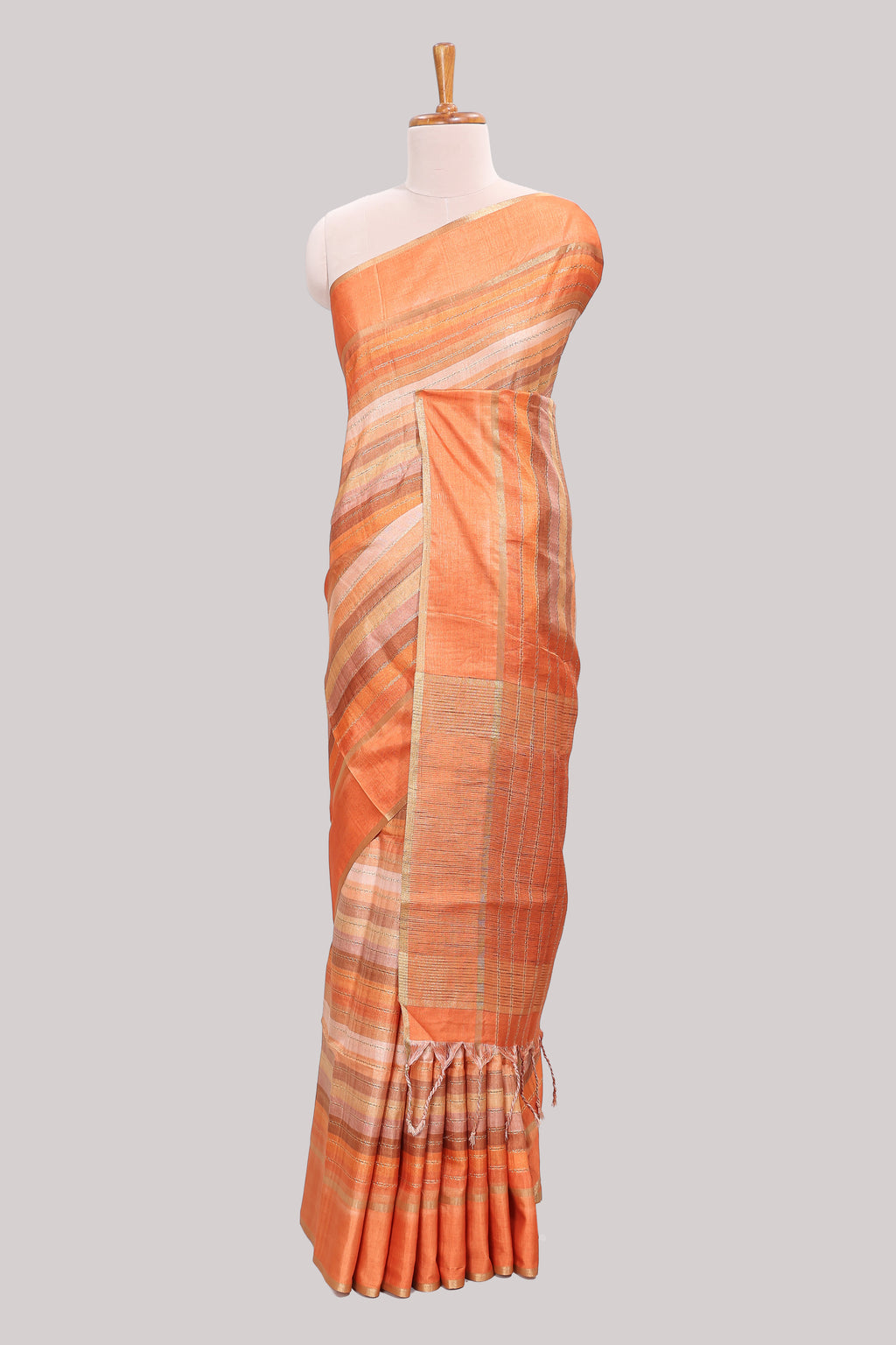 Orange striped tussar saree with self border and pallu that comes with matching blouse