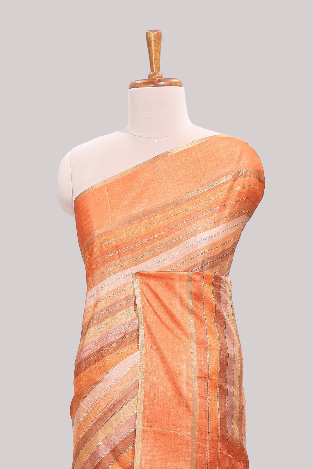 Orange striped tussar saree with self border and pallu that comes with matching blouse
