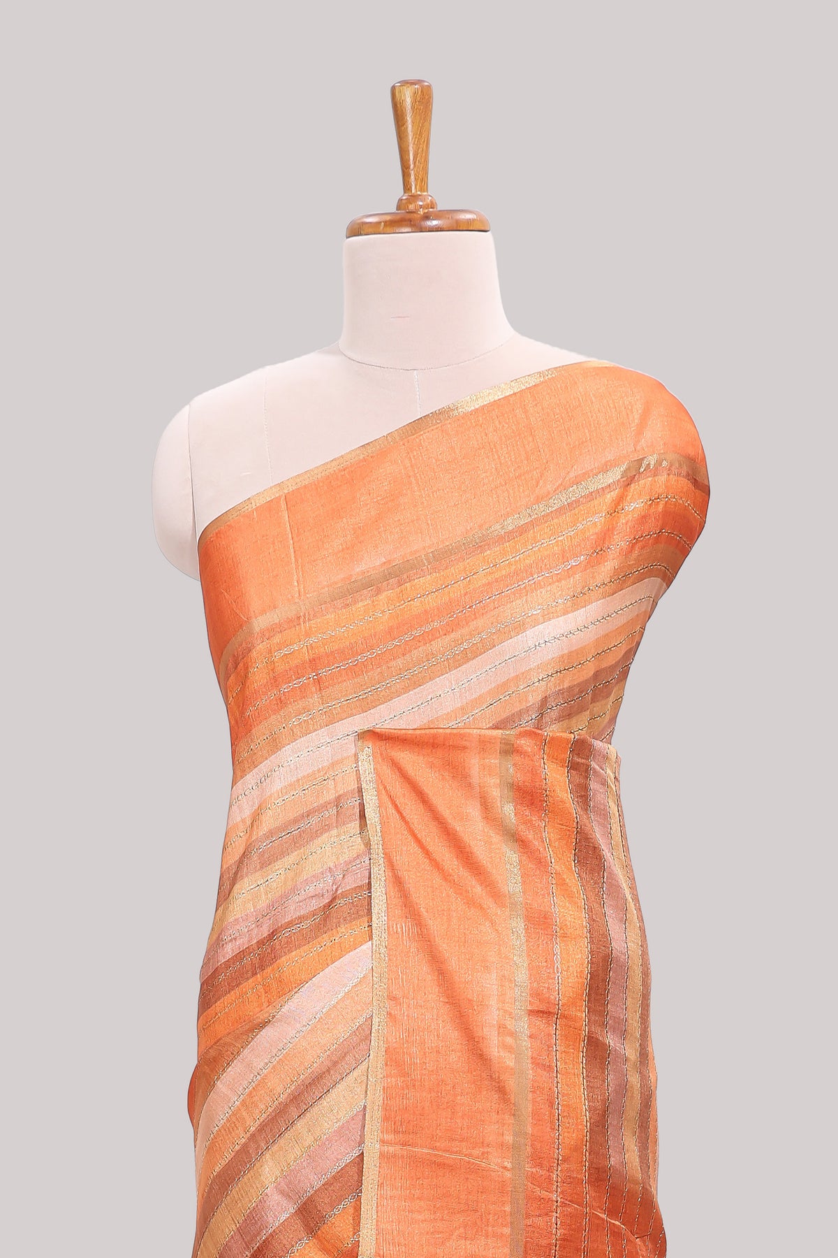 Orange striped tussar saree with self border and pallu that comes with matching blouse