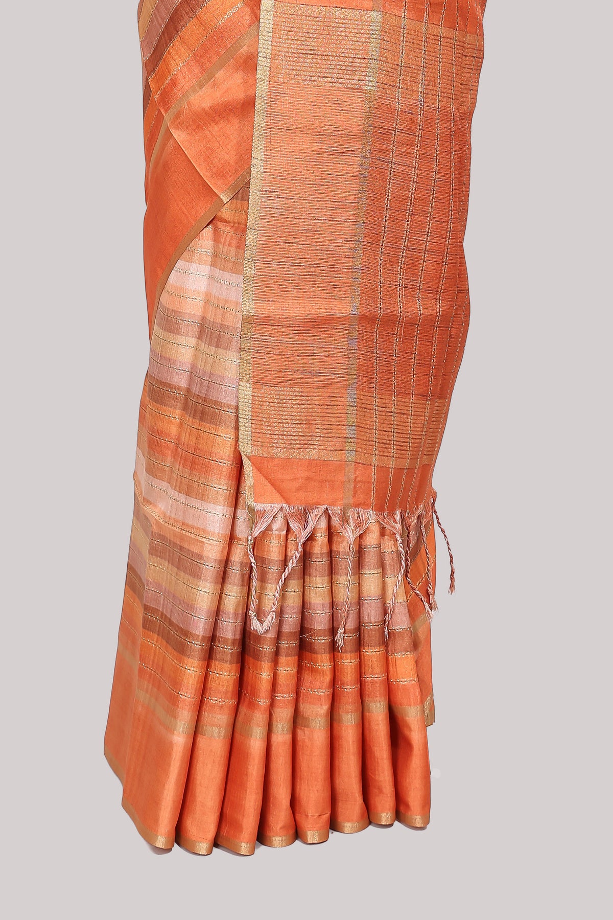 Orange striped tussar saree with self border and pallu that comes with matching blouse