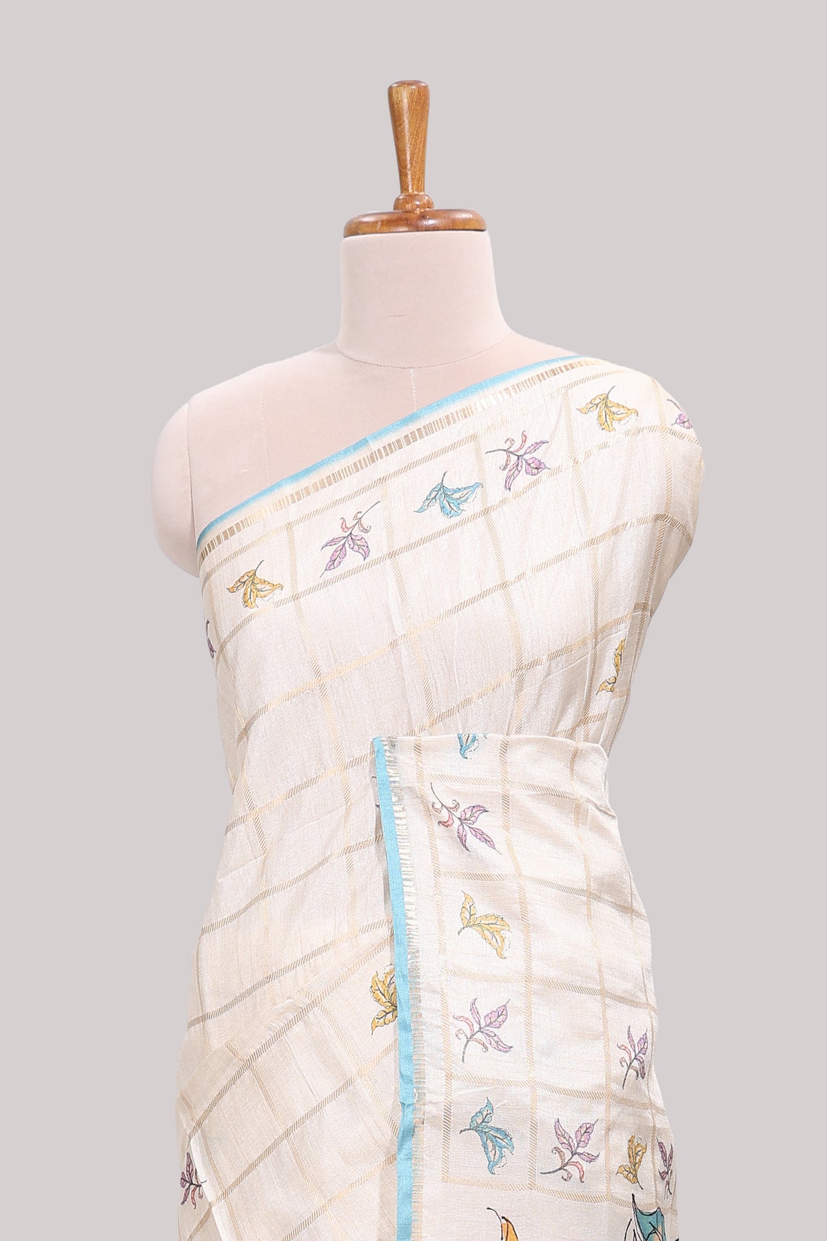 Off white checked tussar saree with contrast border and self pallu that comes with matching blouse