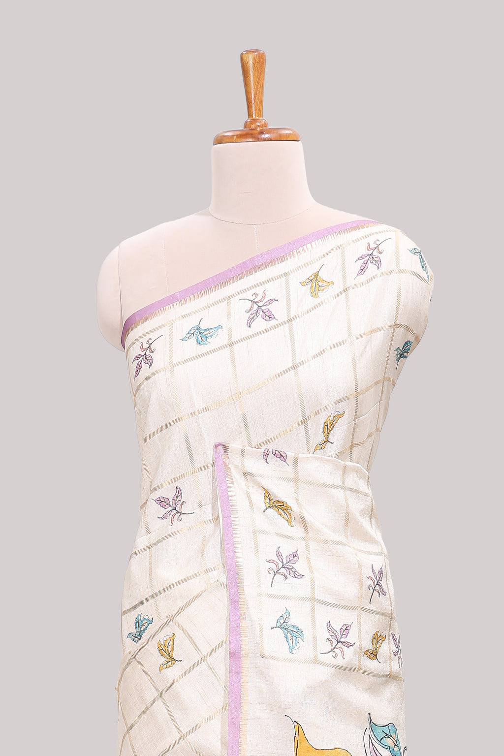 Off white checked tussar saree with contrast border and self pallu that comes with matching floral blouse