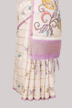 Off white checked tussar saree with contrast border and self pallu that comes with matching floral blouse