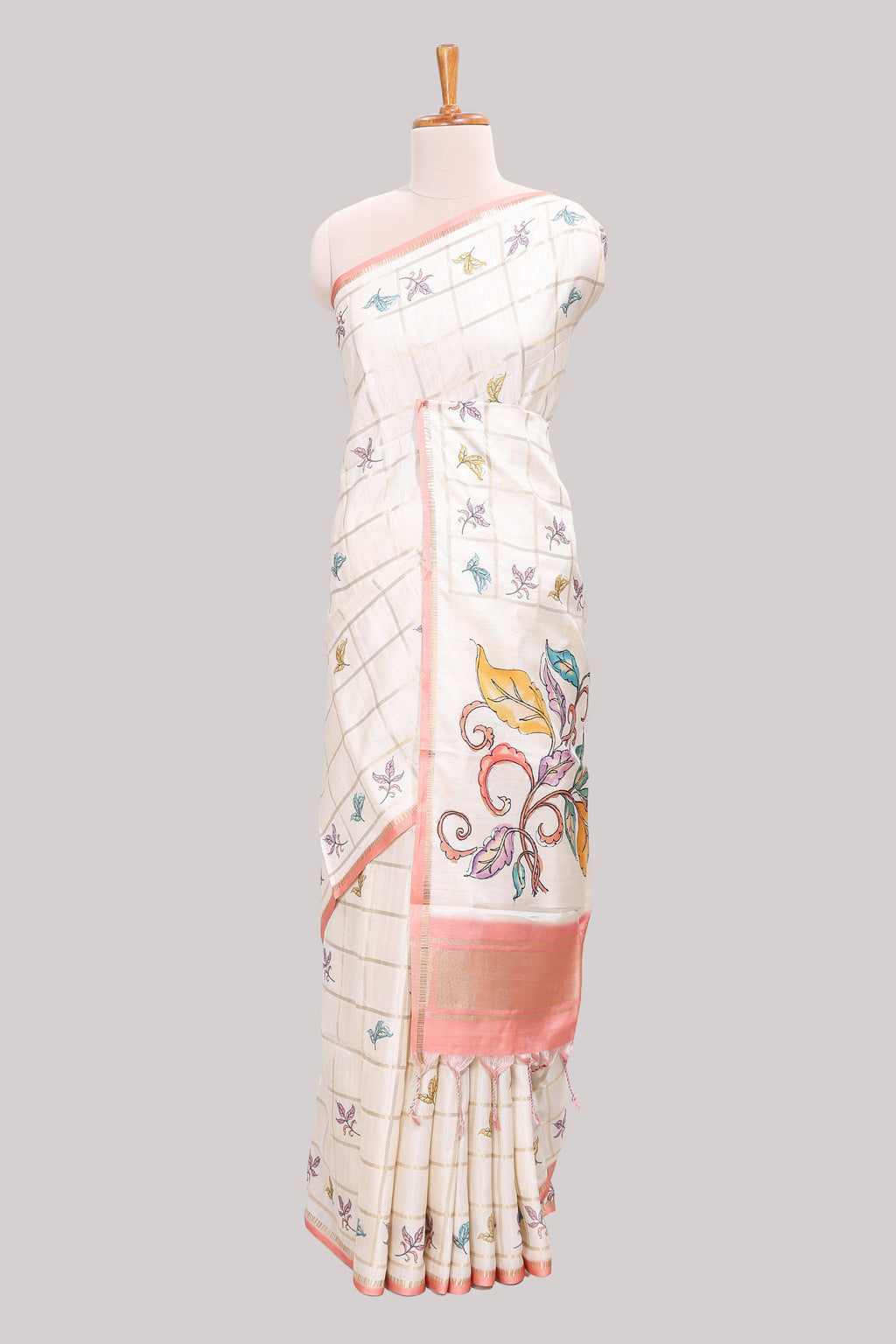 Off white checked tussar saree with contrast border and peach self pallu that comes with matching floral blouse