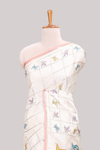 Off white checked tussar saree with contrast border and peach self pallu that comes with matching floral blouse