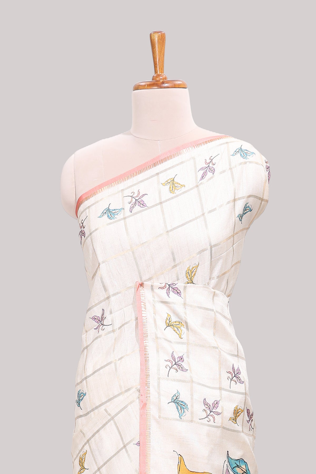 Off white checked tussar saree with contrast border and peach self pallu that comes with matching floral blouse