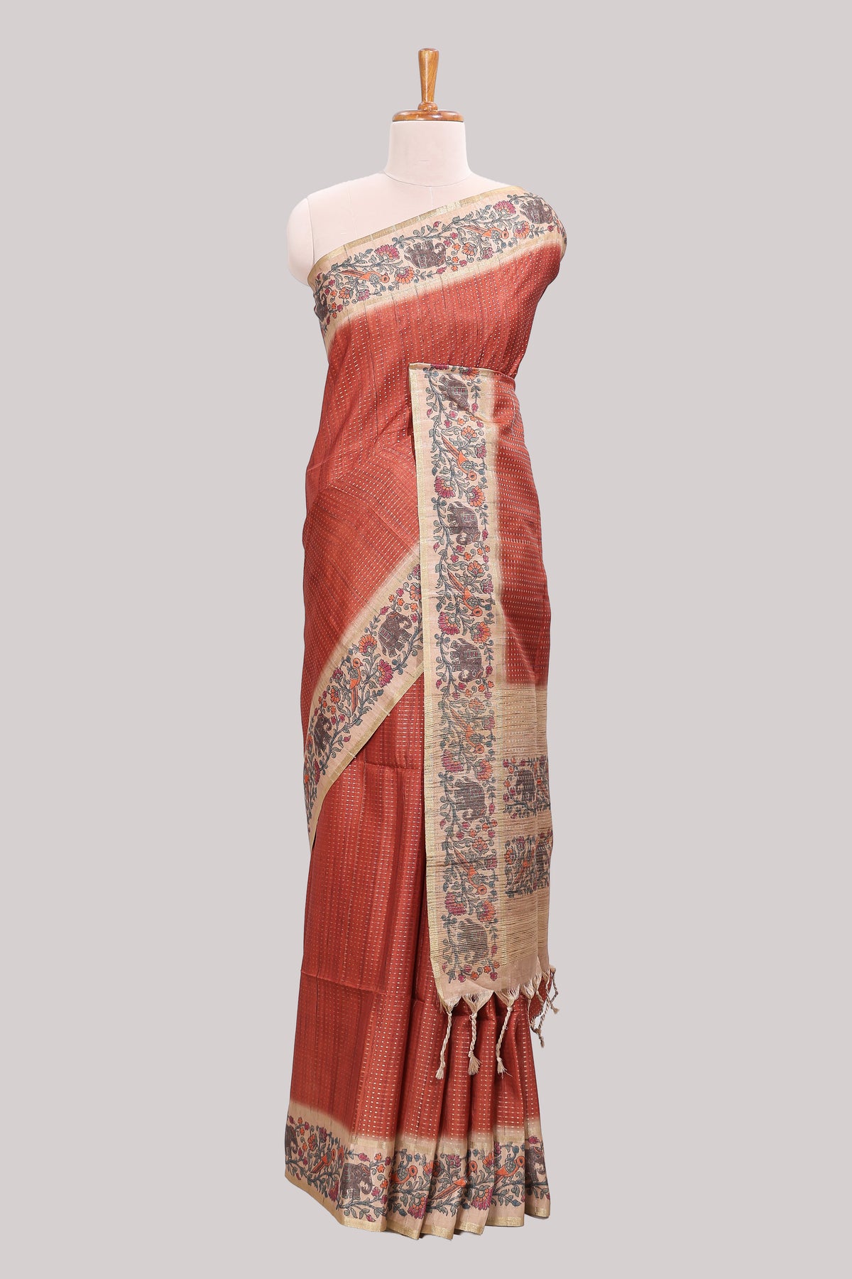 Rust striped tussar saree with contrast border and pallu that comes with plain blouse
