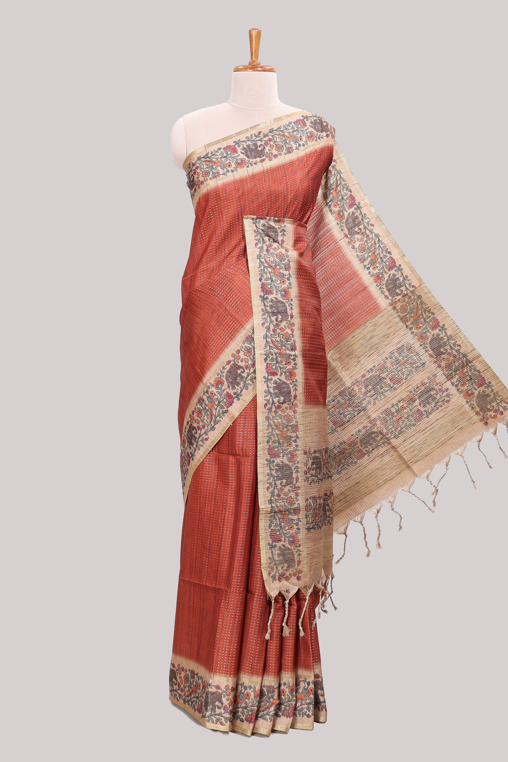 Rust striped tussar saree with contrast border and pallu that comes with plain blouse