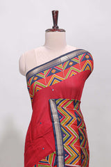 Red embroidery mirror work viscose georgette saree with contrast chevron design zari border and printed pallu