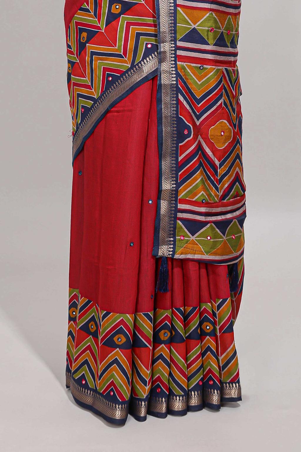 Red embroidery mirror work viscose georgette saree with contrast chevron design zari border and printed pallu
