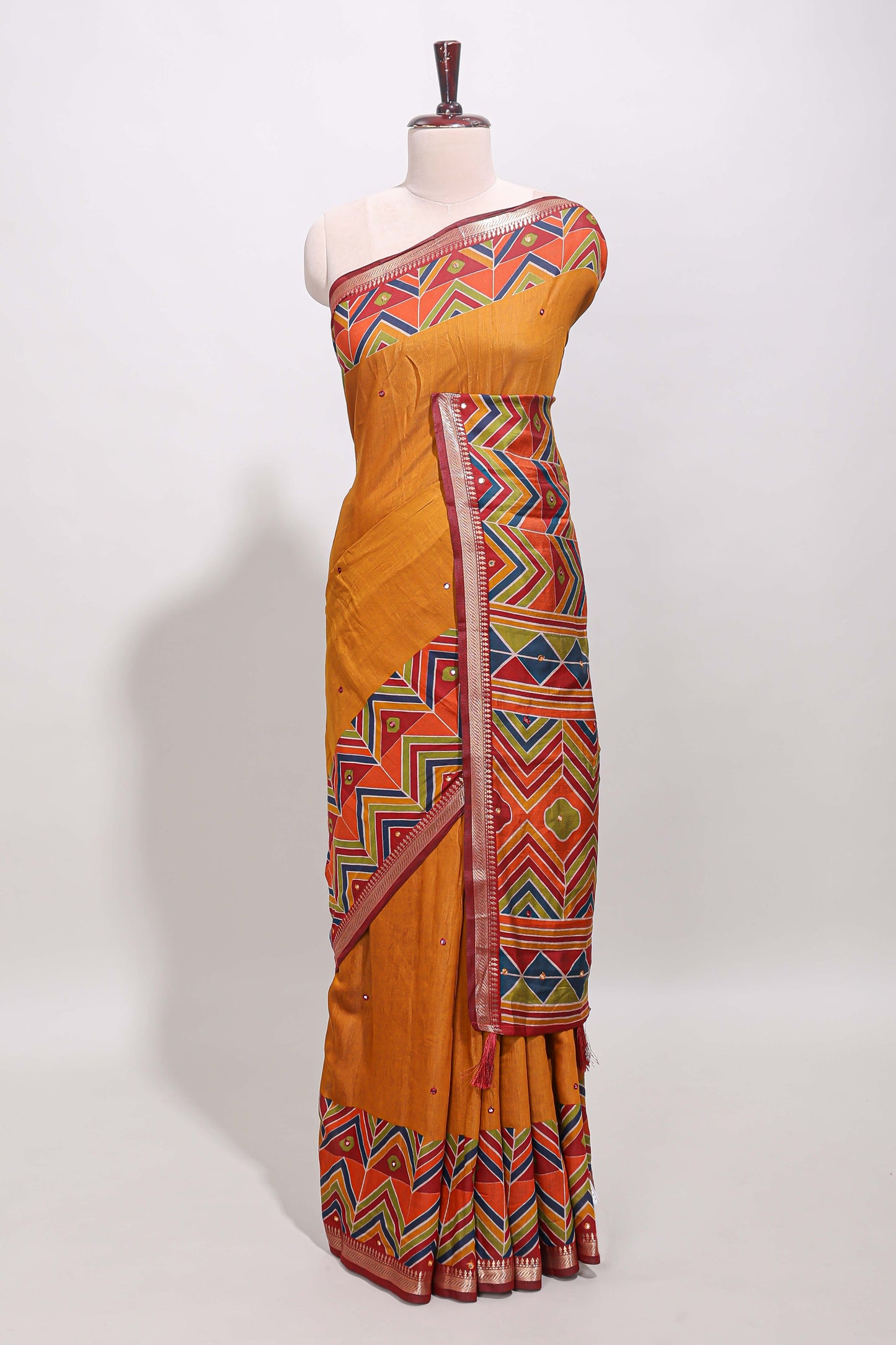 Mustard yellow embroidery mirror work viscose georgette saree with contrast chevron design zari border and printed pallu