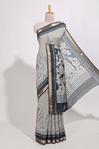 Grey colour viscose georgette saree All-over elegant ethnic detailing gold zari border and Statement pallu with artistic motifs with contrast printed blouse