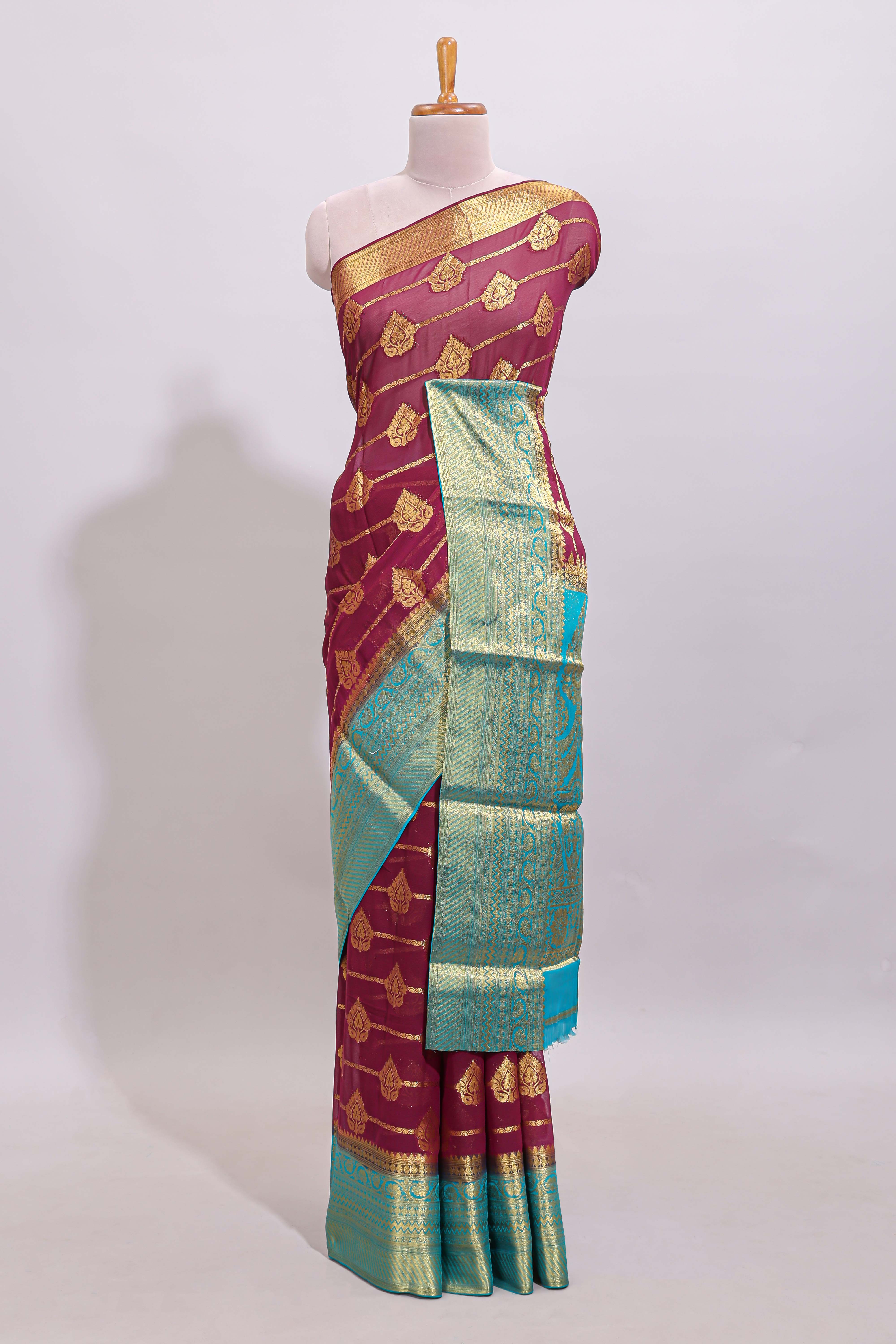 Maroon paisley zari design viscose georgette saree with contrast zari border and blouse