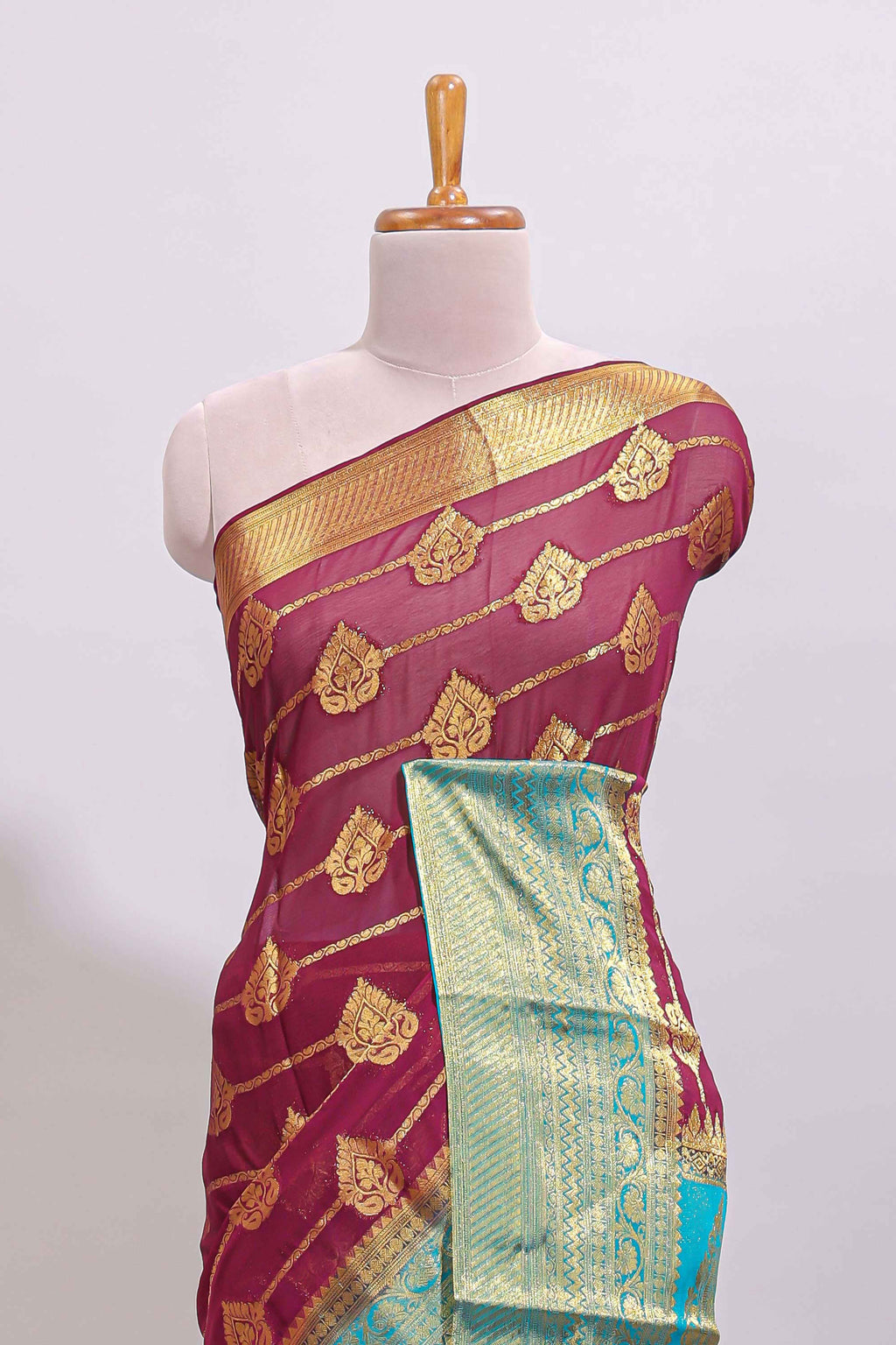 Maroon paisley zari design viscose georgette saree with contrast zari border and blouse