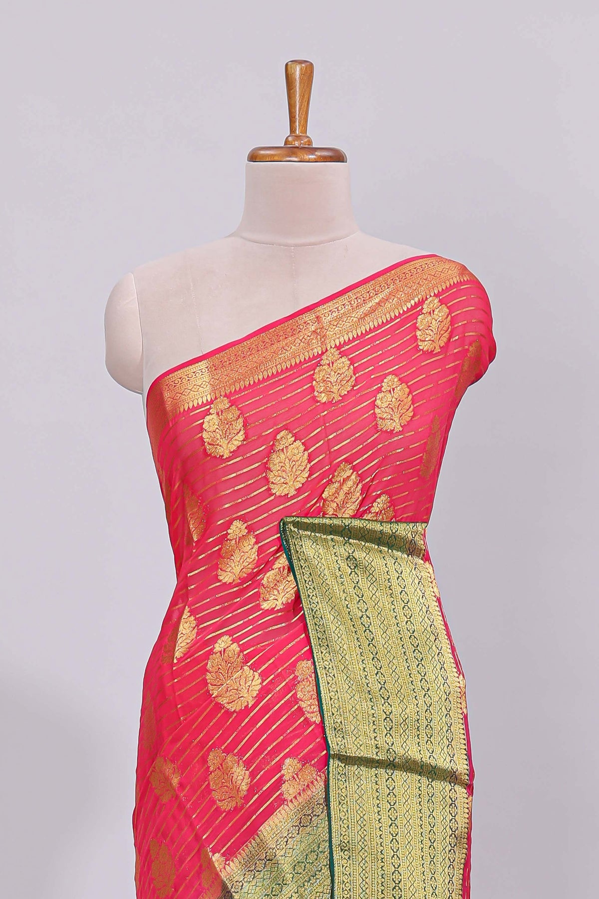 Pink striped floral motifs design viscose georgette saree with contrast checked zari border and blouse