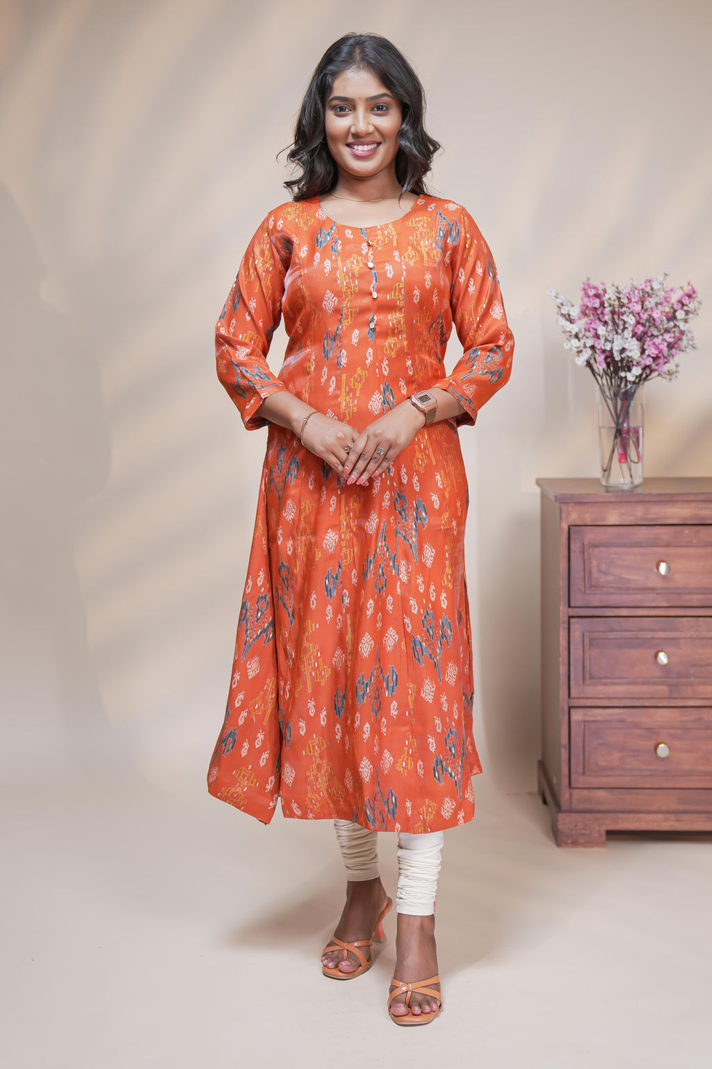 Orange straight anarkali kurti with floral design, round neck and 3/4 sleeves