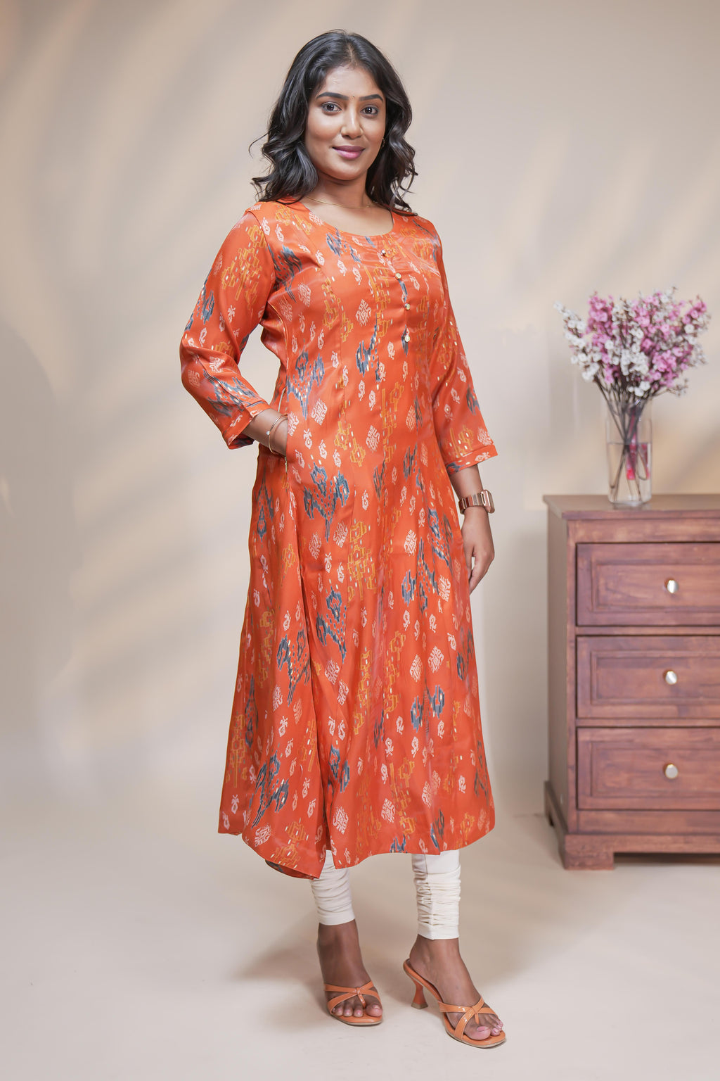 Orange straight anarkali kurti with floral design, round neck and 3/4 sleeves