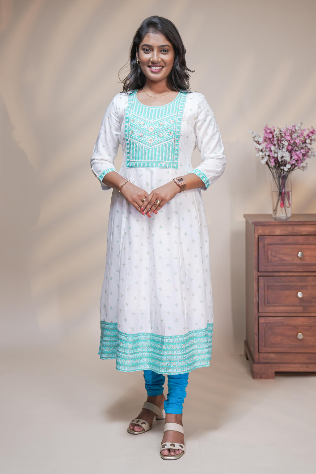 White straight anarkali kurti with butta design, round neck and 3/4 sleeves
