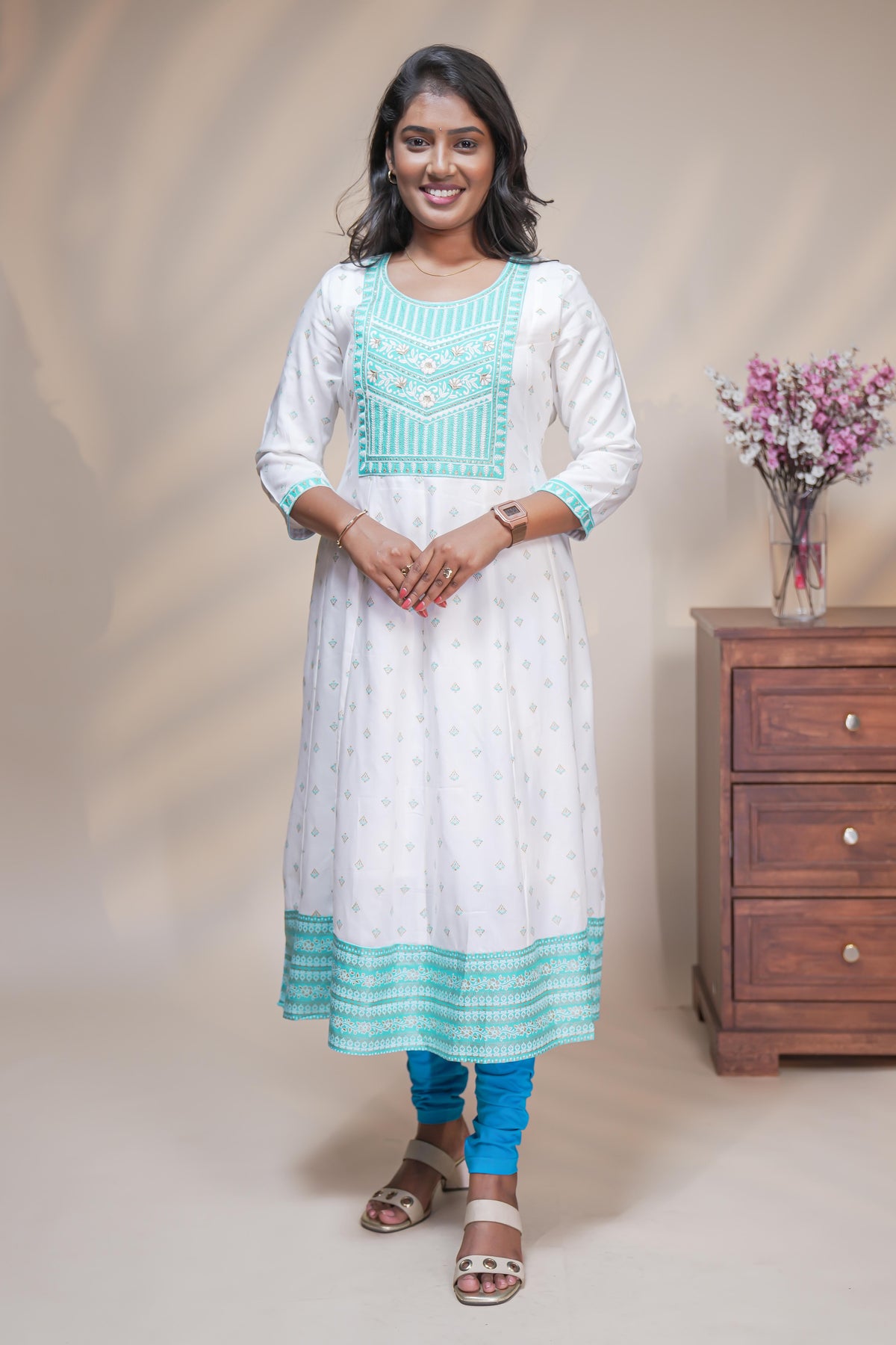 White straight anarkali kurti with butta design, round neck and 3/4 sleeves