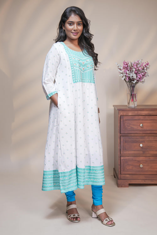 White straight anarkali kurti with butta design, round neck and 3/4 sleeves