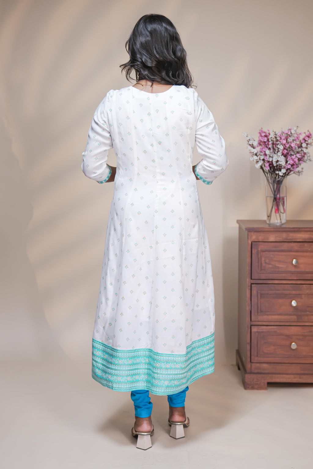 White straight anarkali kurti with butta design, round neck and 3/4 sleeves