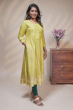 Lime green straight anarkali kurti with polka design, round neck and 3/4 sleeves