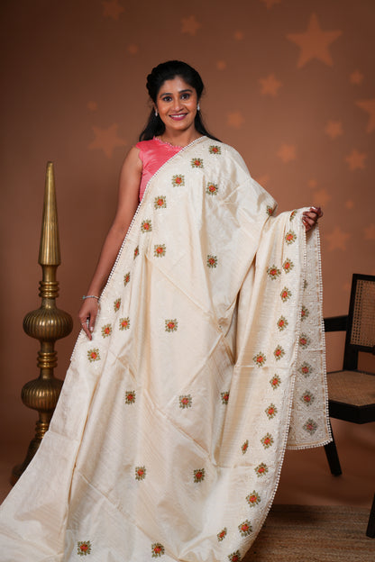 Cream embroidery floral motifs design raw silk saree with self border and matching blouse