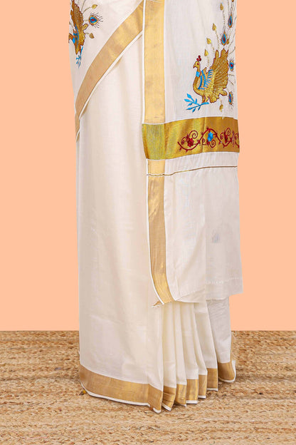 Cream kerala cotton saree with peacock design motifs and golden jari border