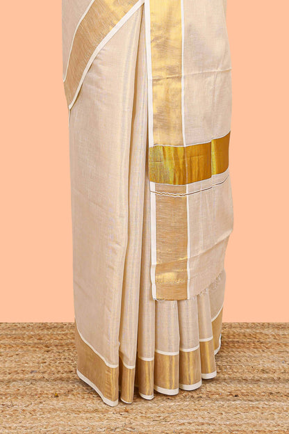 Cream kerala tissue saree featuring a plain body and traditional gold jari border