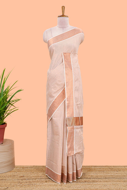 Cream kerala tissue plain saree highlighted by a classic copper jari border