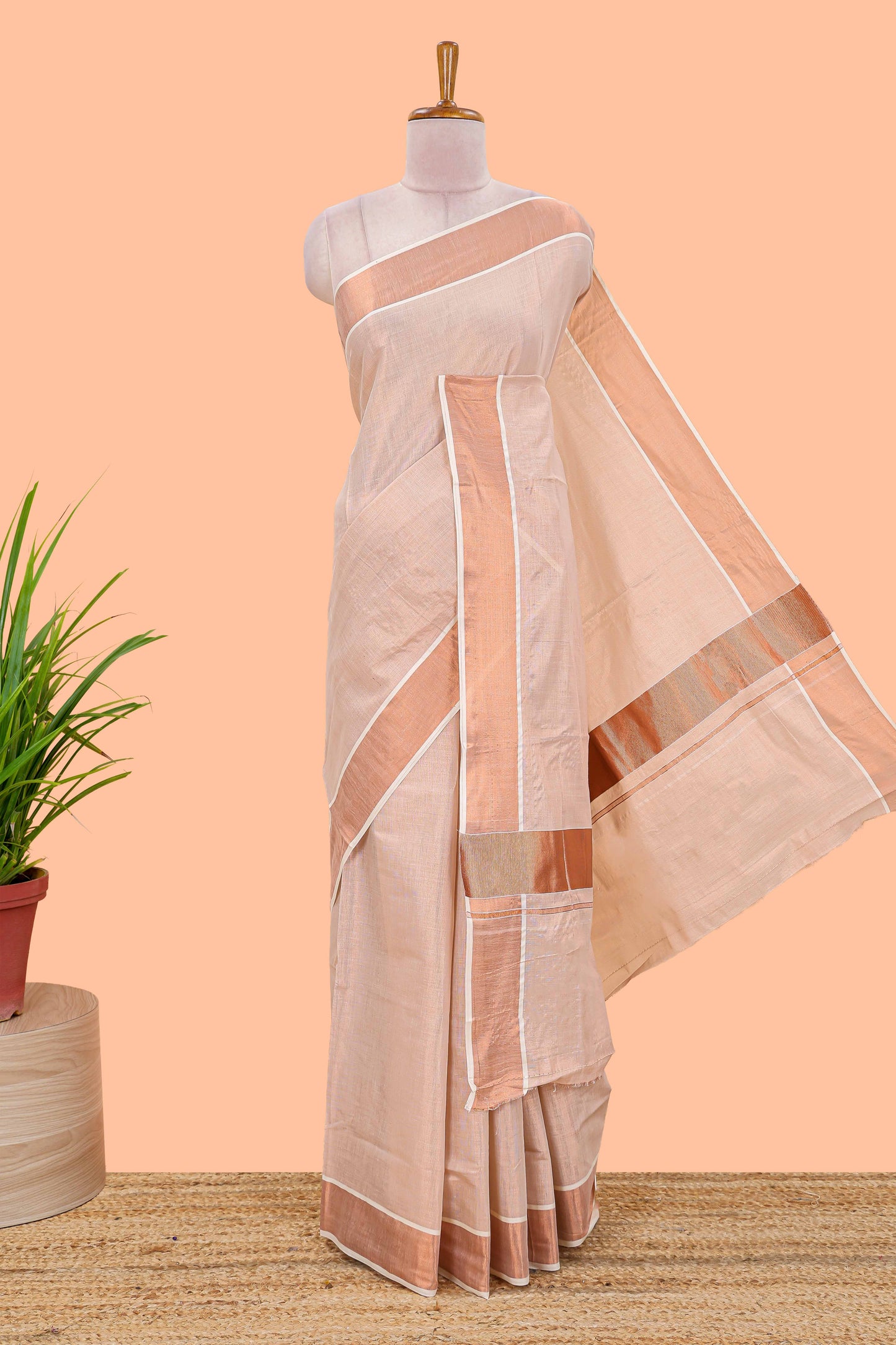 Cream kerala tissue plain saree highlighted by a classic copper jari border