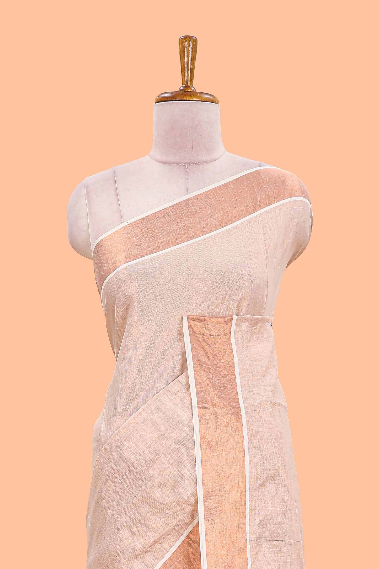 Cream kerala tissue plain saree highlighted by a classic copper jari border